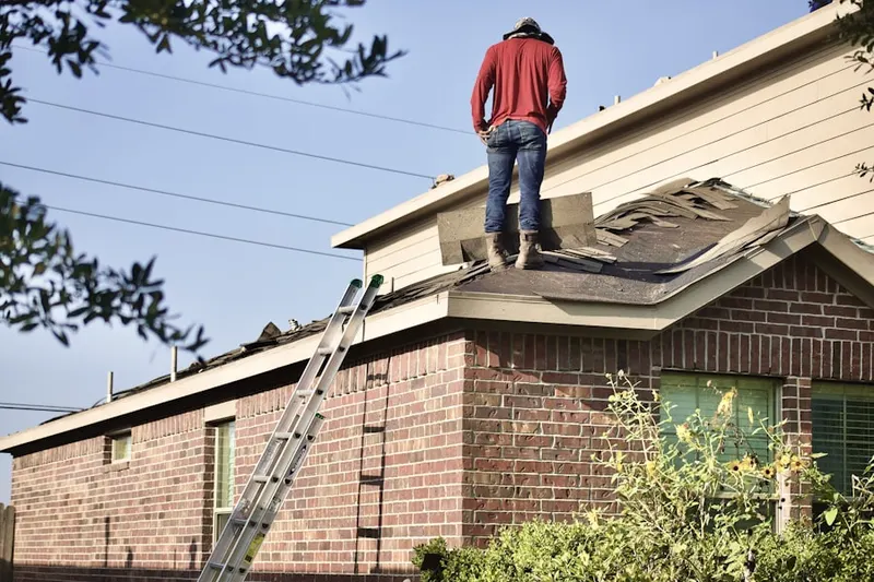 Professional roofer working on a residential roof in Meadowdale